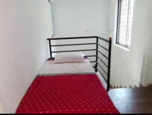 a bed in a room with a red blanket on it at COORG CLlMATE FARM HOUSE in Madikeri +14 photos