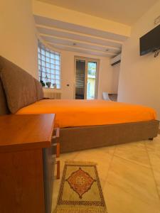a bedroom with a large bed and a couch at Dejavu ROOMS & SPA in Assoro