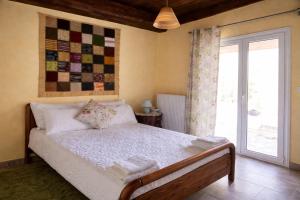 a bedroom with a bed and a window at Villa Dorothy 360 -Mountain Escape in Polydrosos in Polydrossos +5 photos