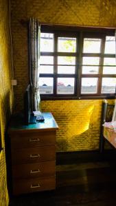 a bedroom with a desk with a computer on it at Cast Away in Nonthaburi