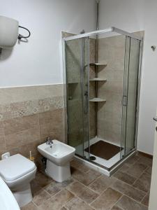 a bathroom with a shower and a toilet and a sink at Costa Del Sole 48 in Camporsevoli +5 photos