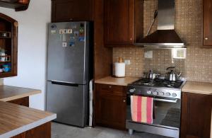 a kitchen with a stainless steel refrigerator and a stove at Villa Dorothy 360 -Mountain Escape in Polydrosos in Polydrossos