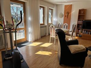 a living room with a chair and a dining room at Ferienwohnung Waldliebe in Waldkirchen
