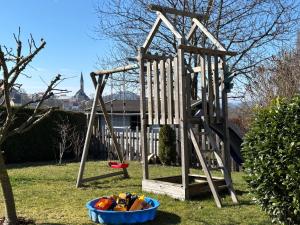 a wooden playground with a blue bowl in the grass at Ferienwohnung Waldliebe in Waldkirchen