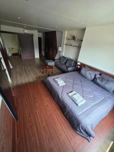 a bedroom with a large bed and a couch at Thaiger House Studios in Bangkok +21 photos