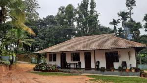 a small house in the middle of a dirt road at BlueMoon Homestay - Near to Falls and View Points, Home Food & Estate in Sakleshpur