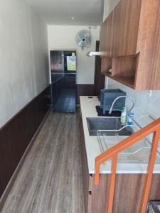 a kitchen with a sink and a counter top at Thaiger House Studios in Bangkok