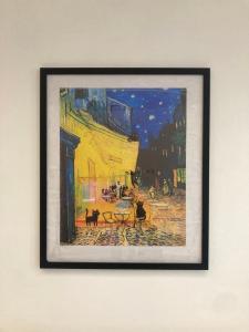 a framed picture of a painting on a wall at UrbaNest WCY in Wakaf Che Yeh