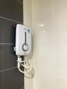 a hair dryer on a wall in a bathroom at UrbaNest WCY in Wakaf Che Yeh +3 photos