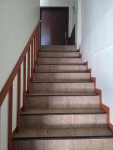 a set of stairs leading up to a door at Thaiger House Studios in Bangkok