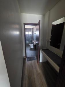 a bathroom with a toilet and a sink and a mirror at Thaiger House Studios in Bangkok