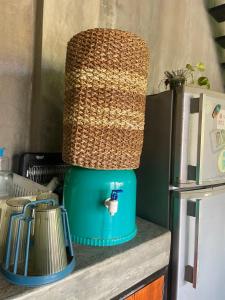 a lamp on top of a counter next to a refrigerator at jbsurf House in Catagnan
