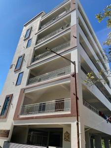 a tall building with balconies on the side of it at XD Hotels 101 in Bangalore