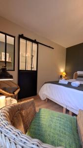 a bedroom with a bed and a window and a couch at LUCIA AL MARE - chambre d'hôtes in Châtelaillon-Plage