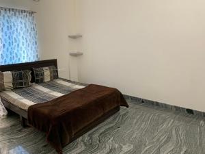 a bedroom with a large bed in a room at XD Hotels 101 in Bangalore