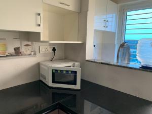 a kitchen with a microwave and a counter top at XD Hotels 101 in Bangalore