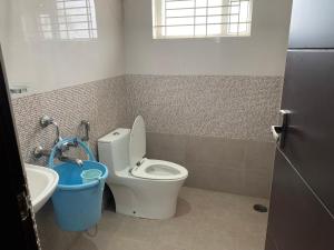 a bathroom with a toilet and a sink at XD Hotels 101 in Bangalore +10 photos