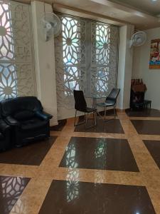 a living room with a glass table and chairs at DelMar by Mery World Hospitality in Pattaya South