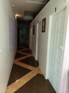 a hallway with white walls and a door and a tile floor at DelMar by Mery World Hospitality in Pattaya South