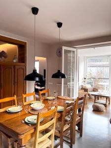 a dining room with a wooden table and chairs at Villa Clair Matin in Ax-les-Thermes