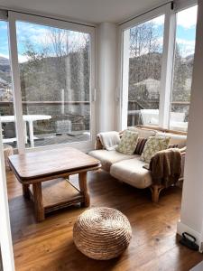 a living room with a couch and a table at Villa Clair Matin in Ax-les-Thermes