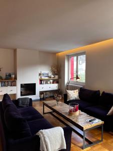 a living room with a couch and a coffee table at Villa Clair Matin in Ax-les-Thermes