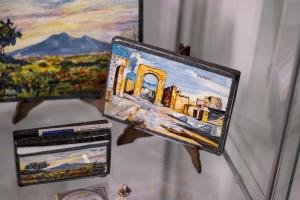 a picture of a painting on a table with a laptop at B & B Victoria in Pompei