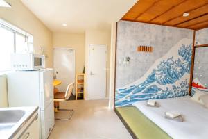 a room with a wave mural on the wall at Court Ada -1min to Araiyakushi-mae Station, 9min train to Shinjuku- 新井薬師前駅徒歩50秒 in Tokyo +175 photos