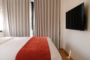 a bedroom with a bed and a flat screen tv at Sadec Garden Boutique Hotel in Ấp Tân Thành (2)