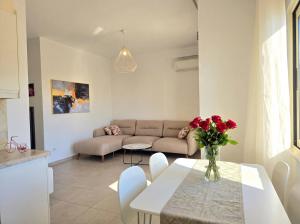 a living room with a table and a couch at Sunny Beach Apartments - 146 in Mullini i Danit