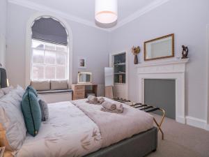 a bedroom with a bed and a fireplace at Stylish Town Apartment in Ross on Wye