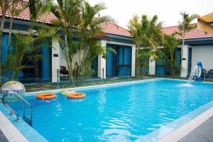 a swimming pool with orange inflatables in a hotel at New Sky Light Villa in Dong Hoi