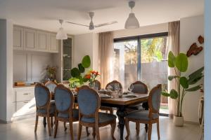 a dining room with a table and chairs at Lindsay Manor Santo Sovrano 4BHK Heated Pool in Vagator