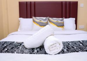 a hotel room with two beds with towels on the bed at Gee Homes and Stays in Nyahururu