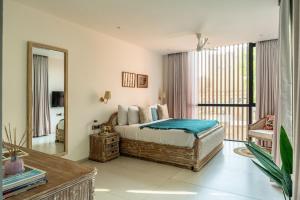 a bedroom with a bed and a large mirror at Lindsay Manor Santo Sovrano 4BHK Heated Pool in Vagator +44 photos