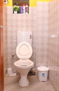 a bathroom with a white toilet in a stall at Gee Homes and Stays in Nyahururu