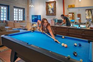 a woman is playing pool in a store at Mingle Lekiu in Kuala Lumpur