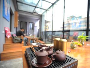 a group of pots on a stove in a room at Shu Hostel in Guiyang