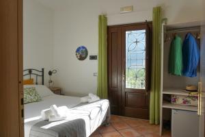 a bedroom with a bed and a window at Casale Del Borgo in San Severino