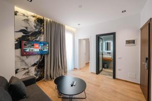 a living room with a couch and a tv on a wall at Hotel Siars in Ksamil +100 photos