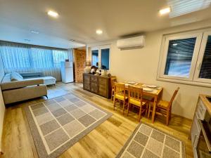 a kitchen and living room with a table and chairs at Wendell Apartman in Nyíregyháza