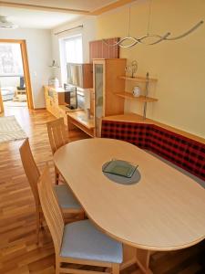 a kitchen with a table and chairs in a room at Riverside Appartements in Lieserbrücke