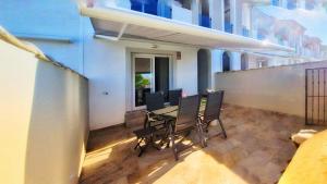 a balcony with a table and chairs in a building at Casa Nina Novastar in San Pedro del Pinatar