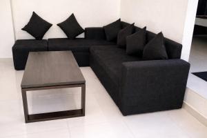 a black couch and a table in a living room at Nisansala Villa in Matara