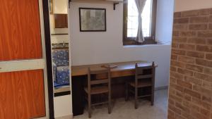 a kitchen with a table and chairs in a room at La Vecchia Posta in Anzano del Parco +8 photos