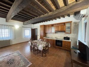 a kitchen with a table and chairs in a room at Agriturismo Aggazzotti in Colombaro