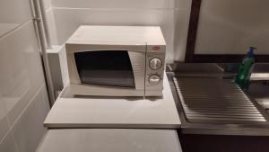 a microwave sitting on a counter in a refrigerator at La Vecchia Posta in Anzano del Parco