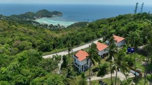 an aerial view of a resort on a hill with the ocean at Karo Villas in Ko Tao