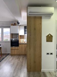 a kitchen with wooden cabinets and a refrigerator at Redi Apartment Center in Elbasan