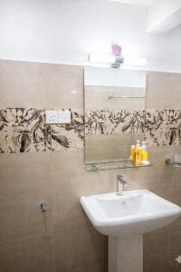 a bathroom with a sink and a mirror at Robert's-stay in Katunayaka